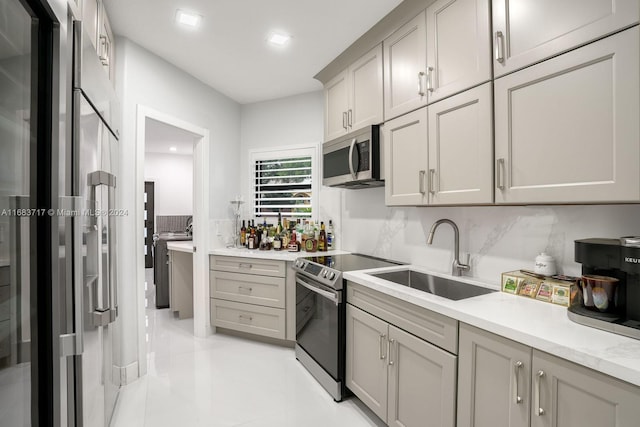 2440 SW 105th Ter, Davie, FL 33324 - kitchen with stainless steel appliances, light countertops, backsplash, light tile patterned flooring, and gray cabinetry