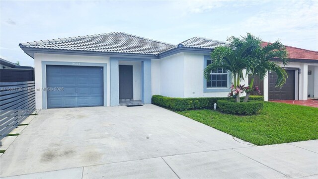 view of front of property with a front yard and a garage