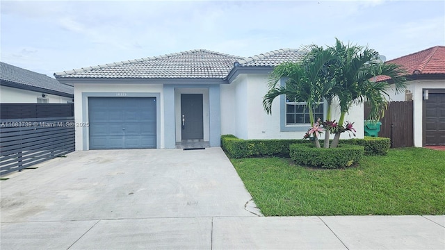 view of front facade with a garage and a front yard