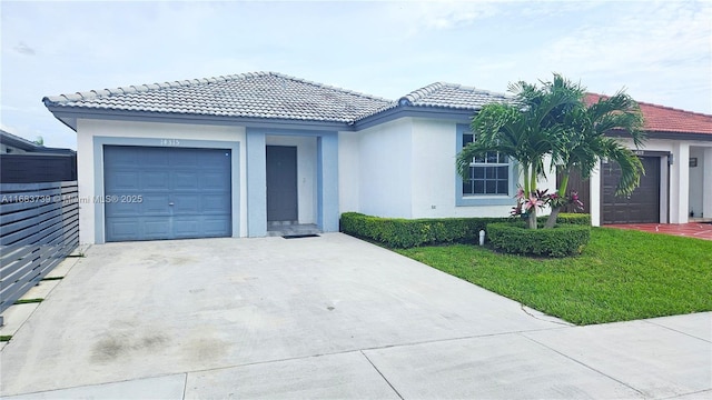 ranch-style home featuring an attached garage, driveway, a front yard, and stucco siding