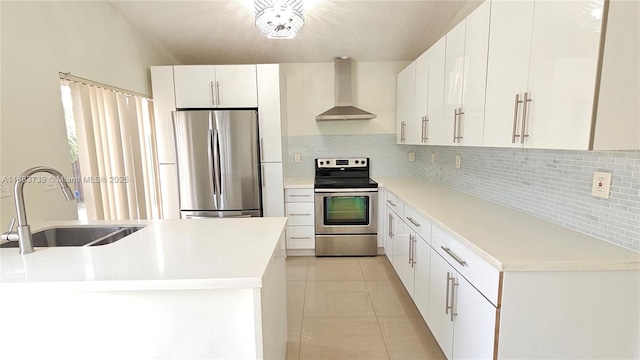 kitchen with light tile patterned flooring, stainless steel appliances, a sink, wall chimney range hood, and decorative backsplash