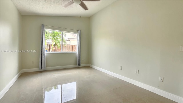 unfurnished room featuring ceiling fan, lofted ceiling, and a textured ceiling