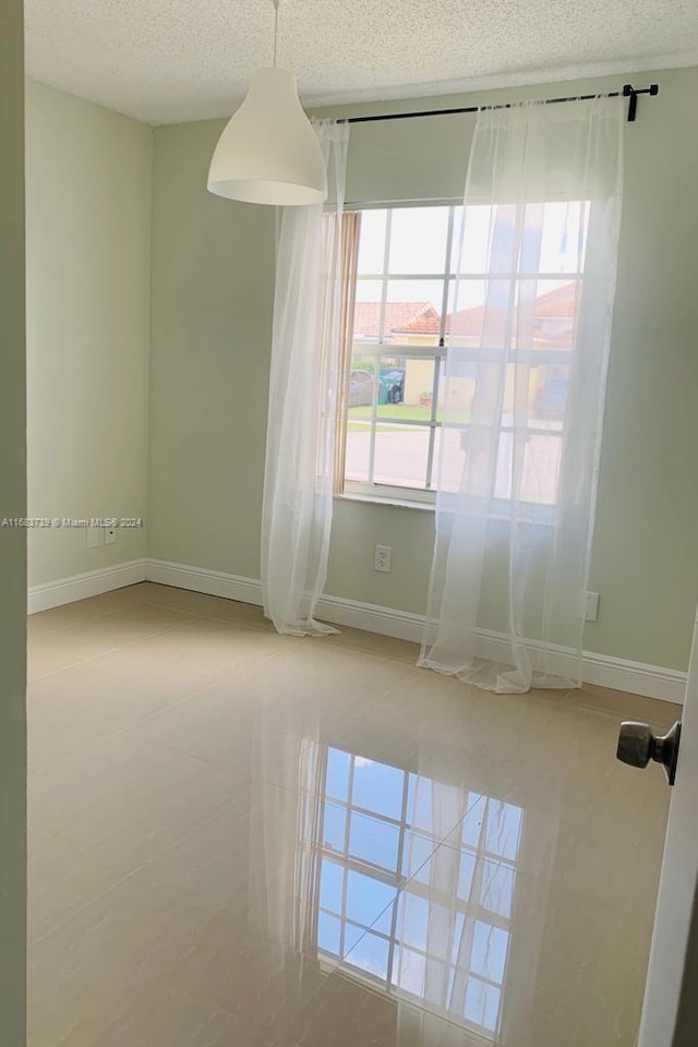 spare room with a textured ceiling