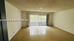 spare room with a textured ceiling