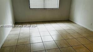 unfurnished room with light tile patterned flooring