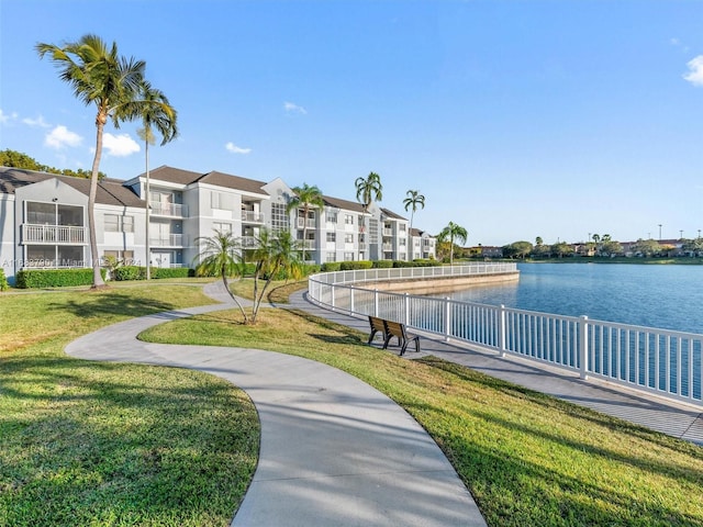 view of home's community featuring a water view and a yard