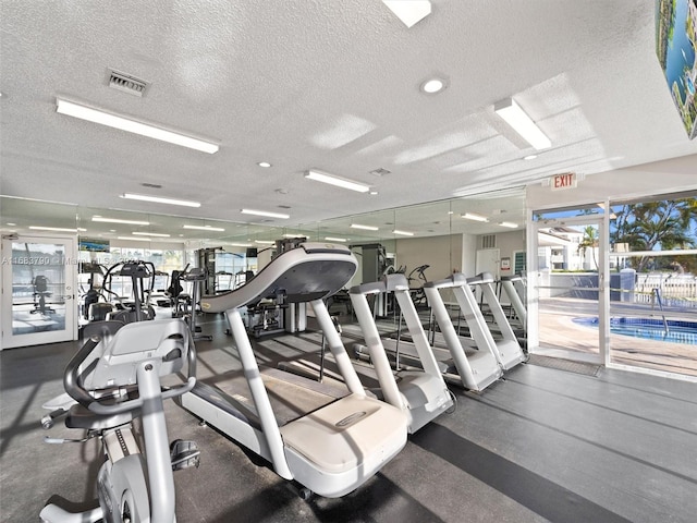 exercise room featuring a textured ceiling