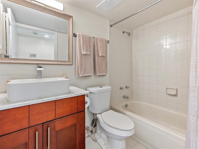 full bathroom with tile patterned floors, vanity, shower / bath combo, and toilet