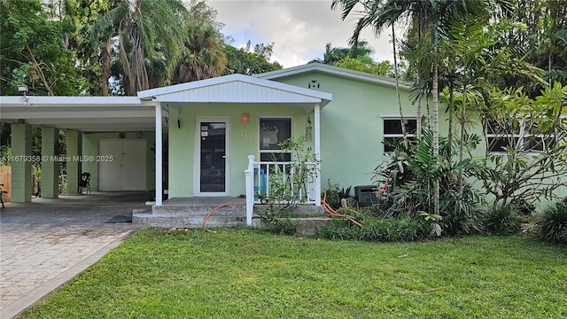 view of front facade featuring a porch, a front lawn, and a carport