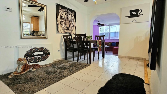 tiled dining space featuring ceiling fan