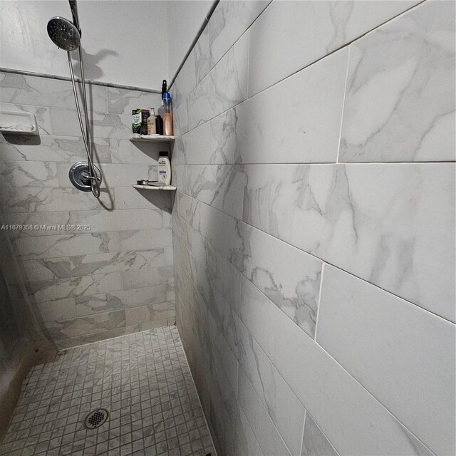 bathroom with a tile shower