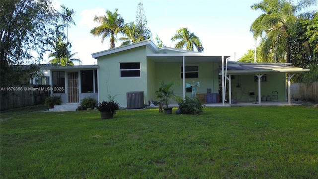 back of property with a lawn, a patio area, and cooling unit