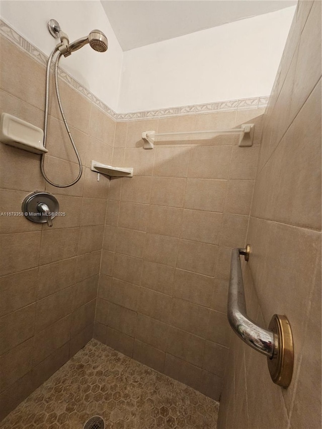 bathroom with a tile shower