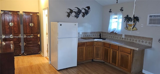 kitchen with light wood-type flooring and white refrigerator