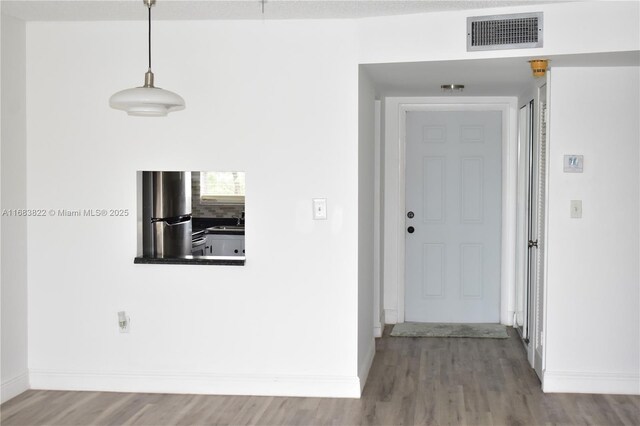 corridor with sink and hardwood / wood-style flooring