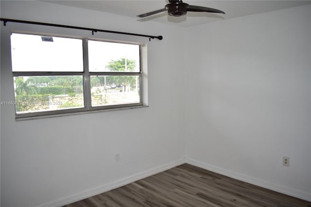 spare room with ceiling fan and dark hardwood / wood-style floors