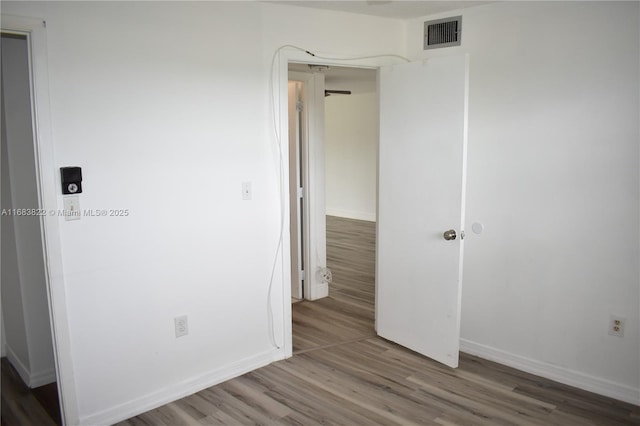 spare room featuring hardwood / wood-style flooring