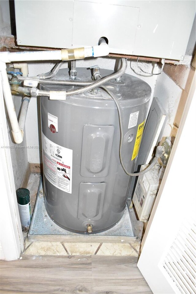 utility room featuring water heater