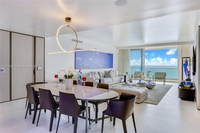 dining area with a water view and floor to ceiling windows