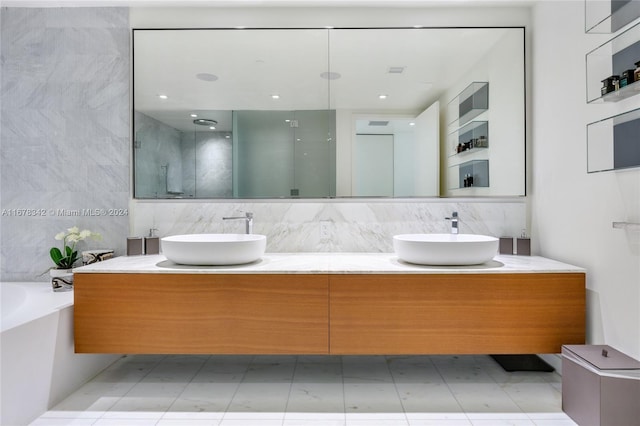 bathroom featuring vanity, tile walls, and separate shower and tub