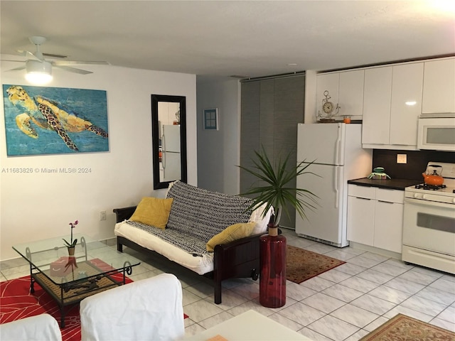 living room featuring ceiling fan and light tile patterned floors