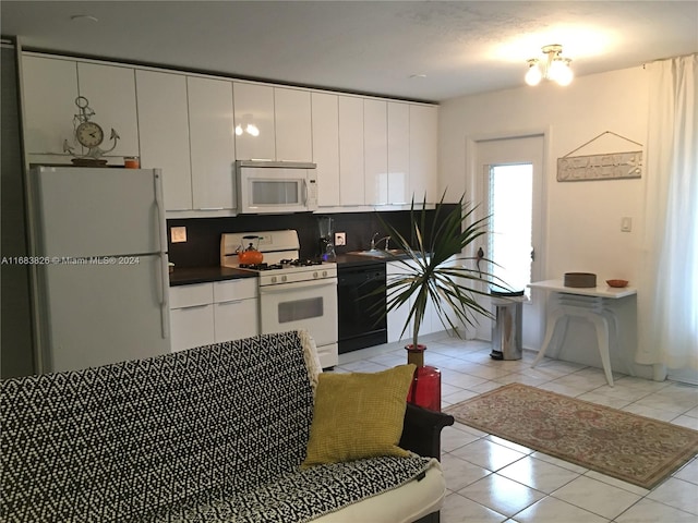 kitchen featuring backsplash, white cabinetry, light tile patterned flooring, sink, and white appliances