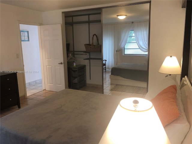 tiled bedroom with a closet