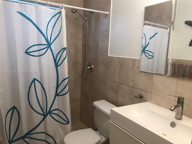 bathroom featuring backsplash, walk in shower, tile walls, toilet, and vanity