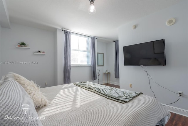 bedroom with dark hardwood / wood-style flooring