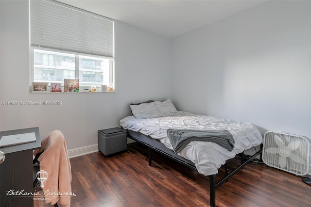 bedroom with dark hardwood / wood-style floors