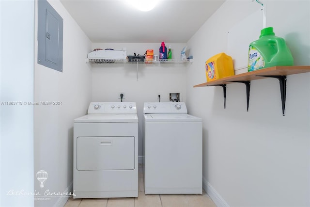 washroom featuring washer and dryer, electric panel, and light tile patterned flooring