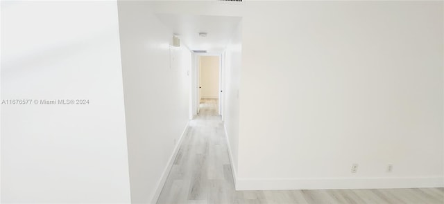 hallway with light hardwood / wood-style flooring