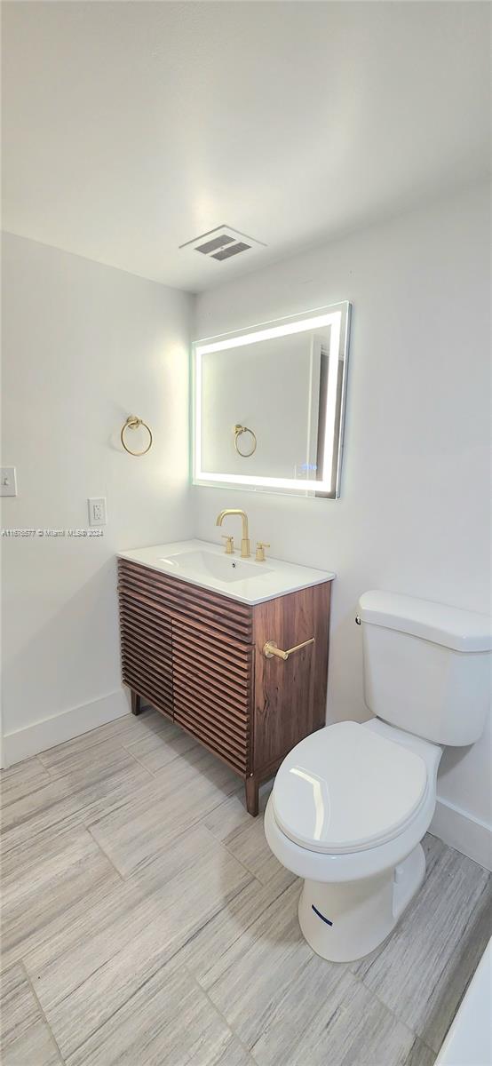 bathroom featuring vanity and toilet