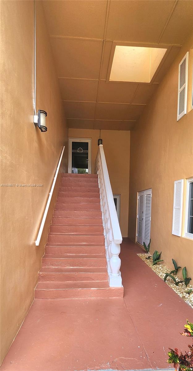 stairway featuring a paneled ceiling