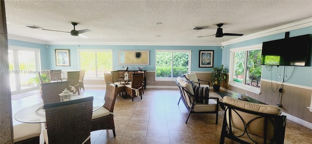 dining space featuring ceiling fan, a textured ceiling, and a wealth of natural light