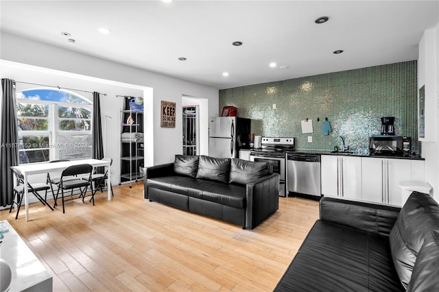 living room featuring sink and light wood-type flooring