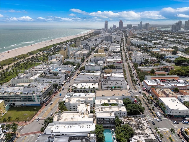 drone / aerial view with a water view and a beach view