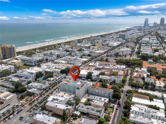 aerial view with a water view and a beach view