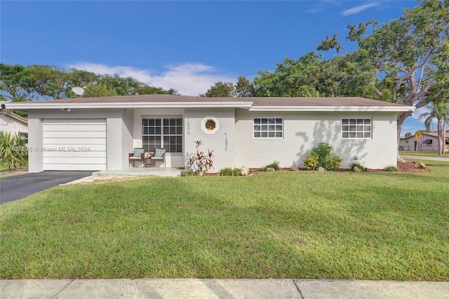 ranch-style house featuring a garage and a front yard