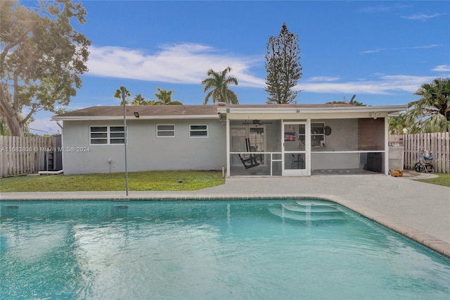 view of pool featuring ceiling fan, a lawn, and a patio area