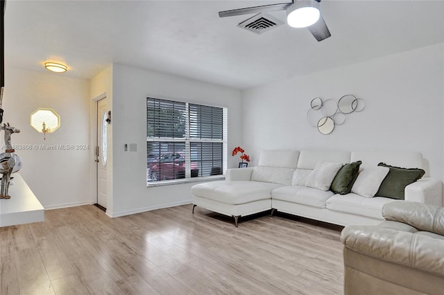 living room with light wood-type flooring and ceiling fan