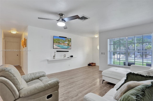 living room featuring ceiling fan and light hardwood / wood-style flooring