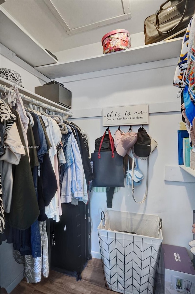 walk in closet with dark hardwood / wood-style flooring