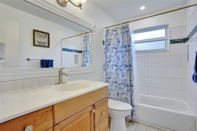 full bathroom with shower / tub combo with curtain, vanity, and toilet