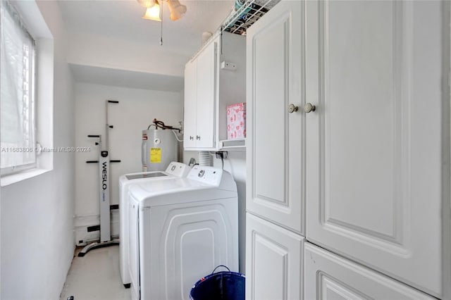 clothes washing area with cabinets, washing machine and dryer, ceiling fan, and electric water heater