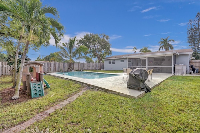 view of pool featuring a patio, a sunroom, and a yard