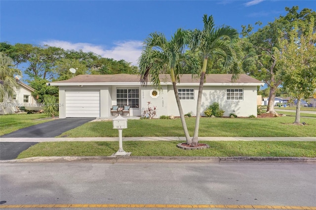 ranch-style home with a garage and a front yard