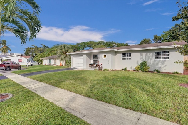 ranch-style house with a garage and a front yard