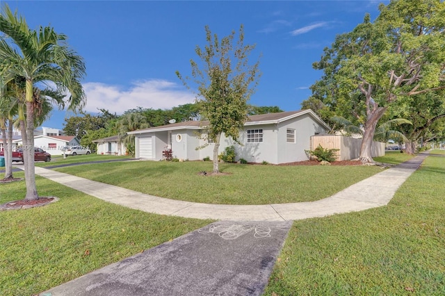 view of front of home with a garage and a front lawn