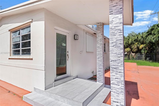 property entrance with a patio